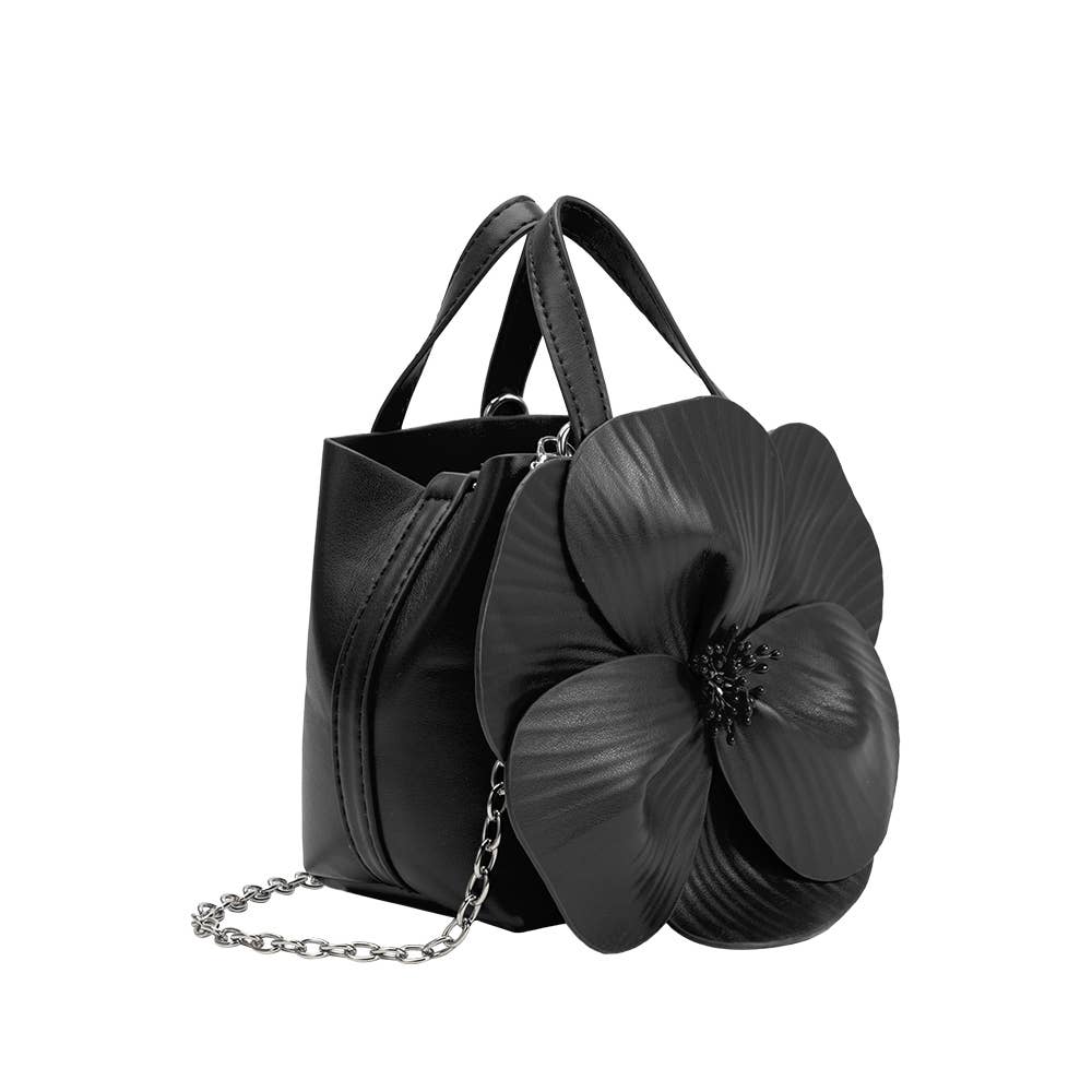 side view of black handbag with large 3d flower and chain crossbody