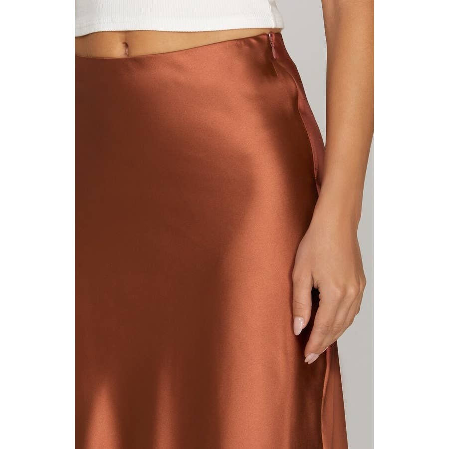 copper satin skirt worn by a person on a white background