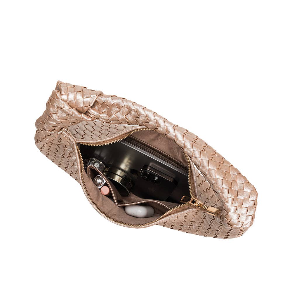 interior view of woven handbag with knit in strap on white background