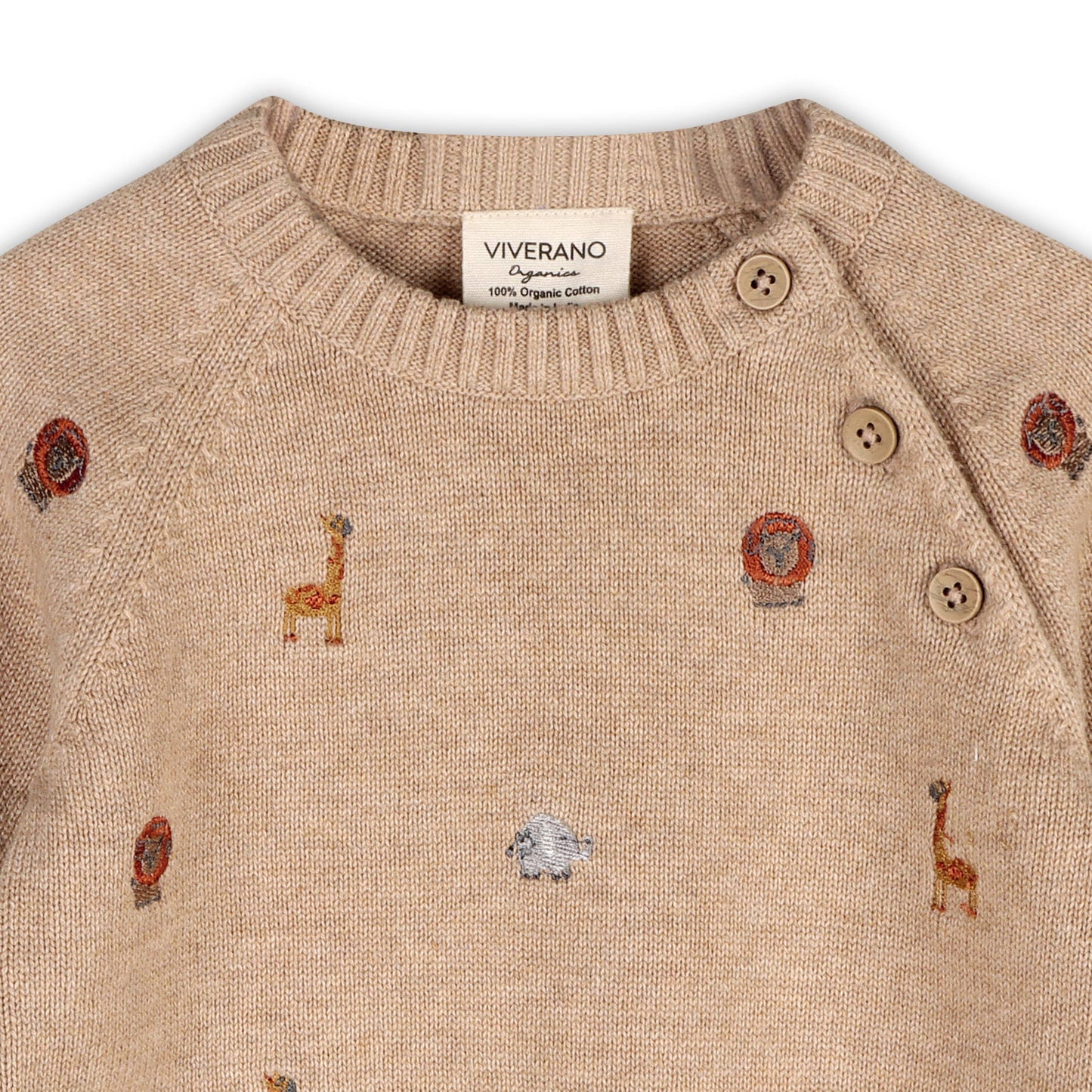 close up of light brown sweater knit raglan sleeve baby pullover, featuring safari animals embroidery