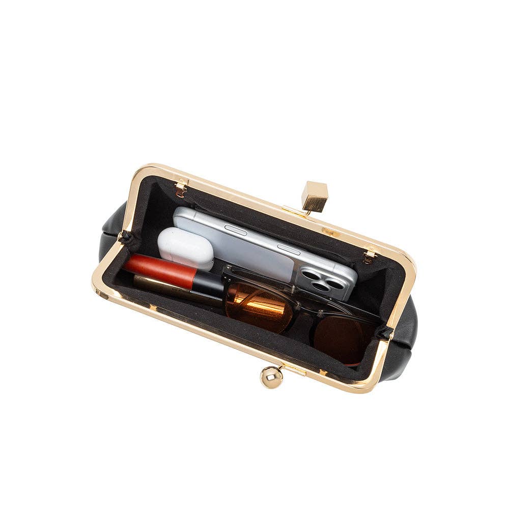 A black kiss-lock clutch bag with a gold-tone metal frame, shown open to reveal a black interior organizer holding a smartphone, white earbuds case, red lipstick, and a brown bottle.