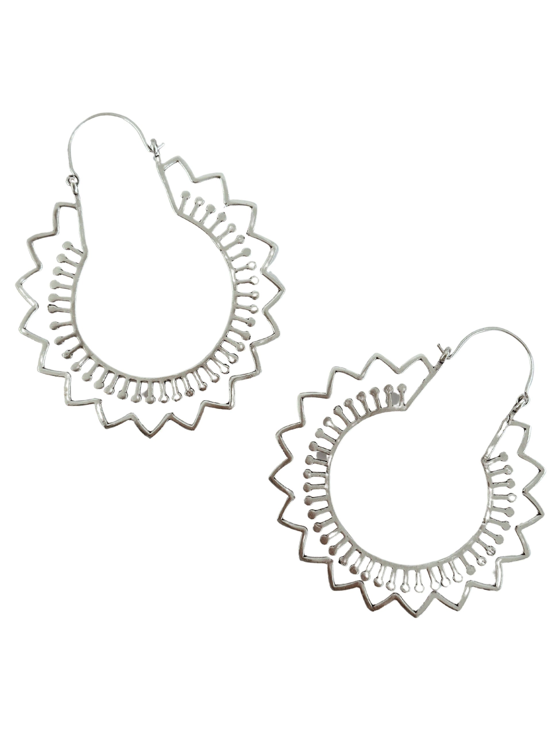 Silver plated hoop earrings with stylized flower detail shapes. on a white background.