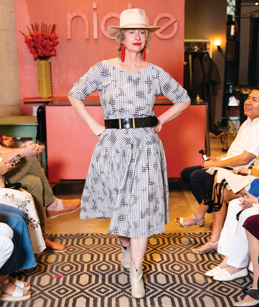 model in a grey plaid top with a matching skirt