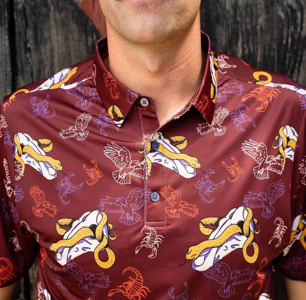 male model wearing a close-up of a maroon shirt with skull print