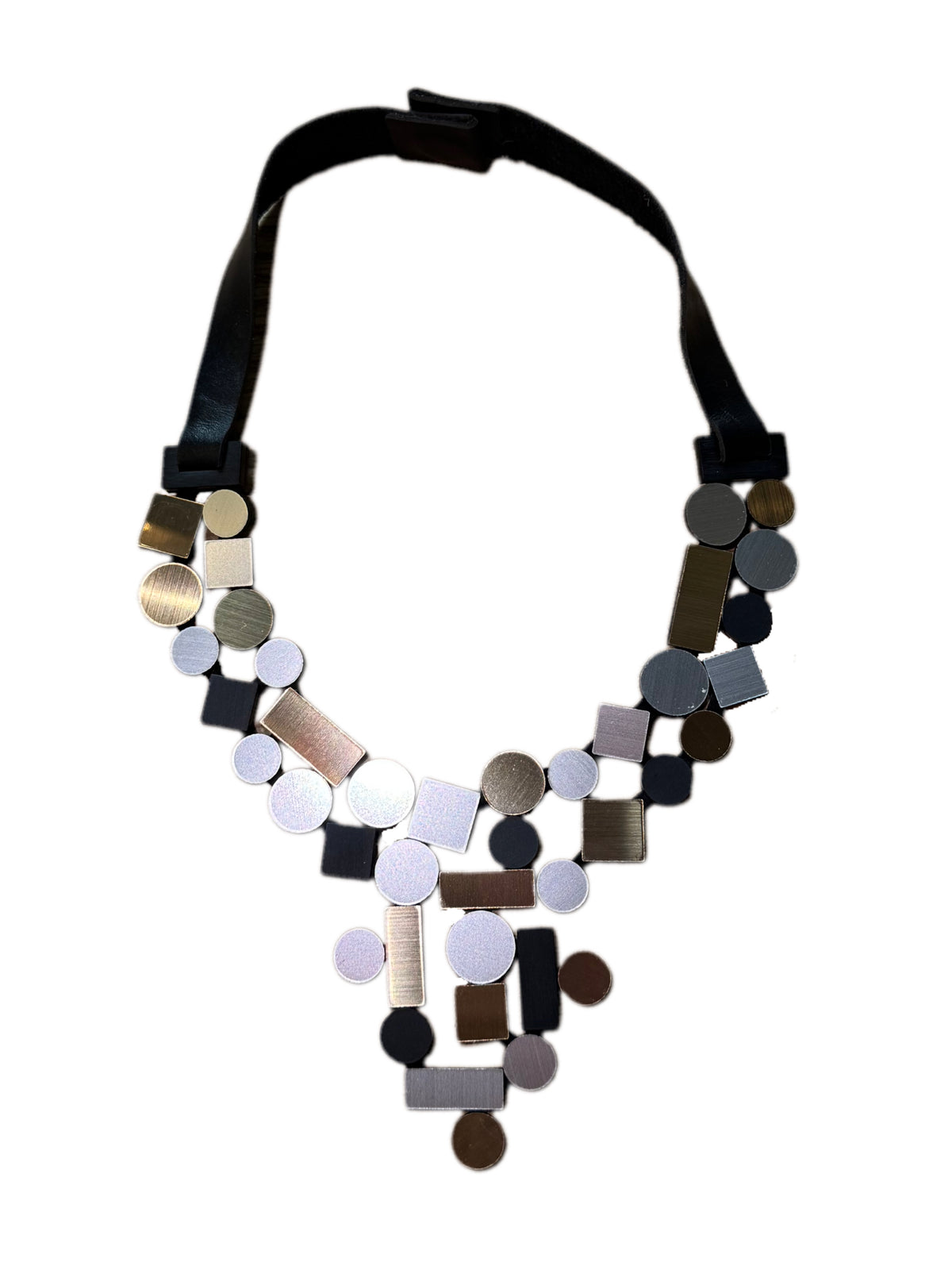 Silver, gold and black geometric shaped necklace against white background