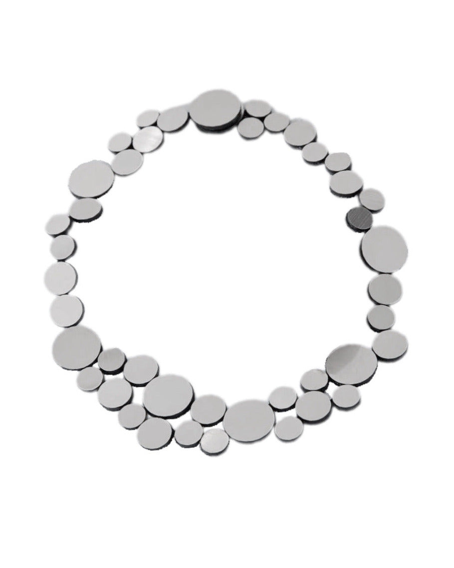 Silver circle cluster necklace against white background