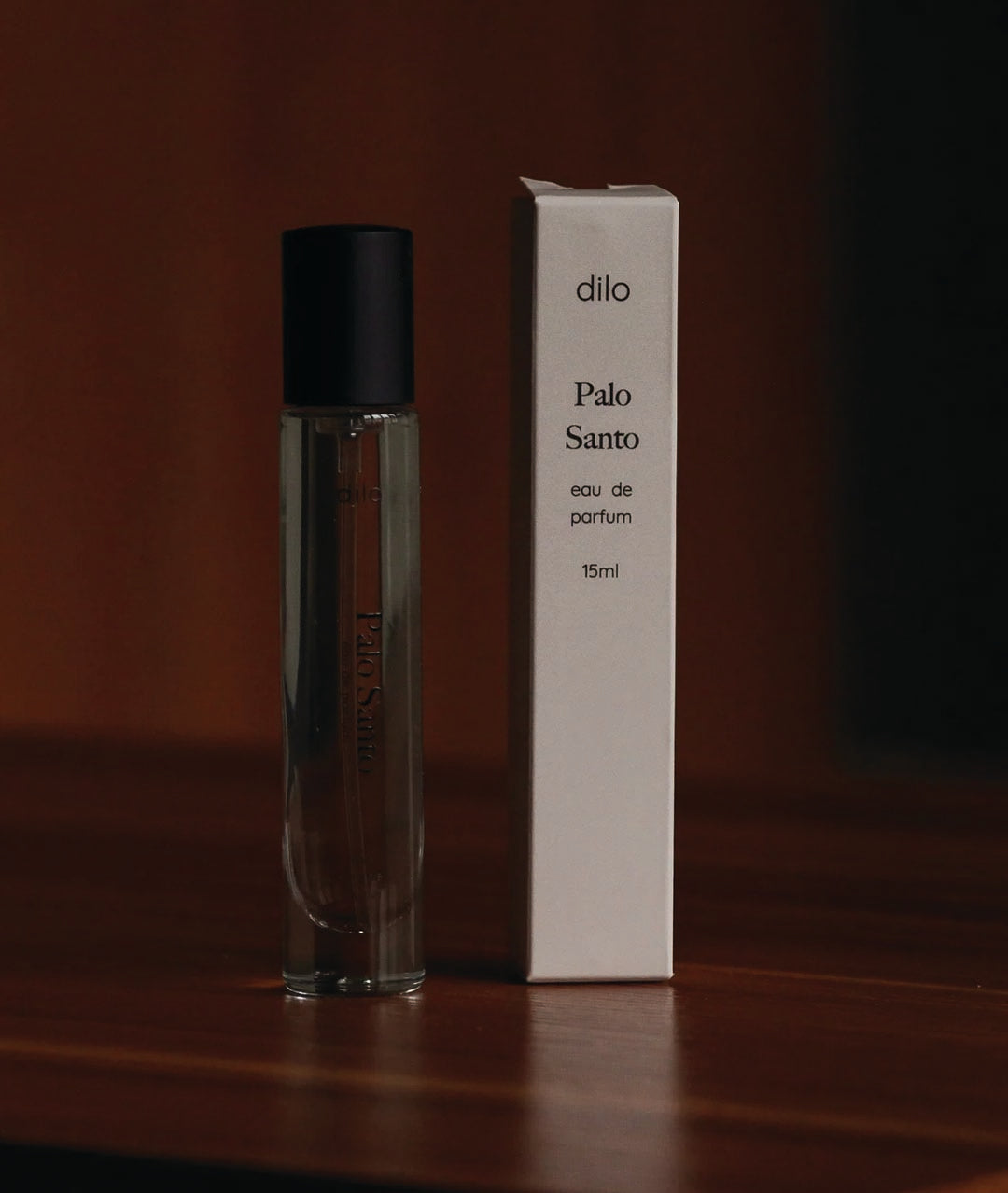 palo santo scented perfume bottle with packaging on wood table