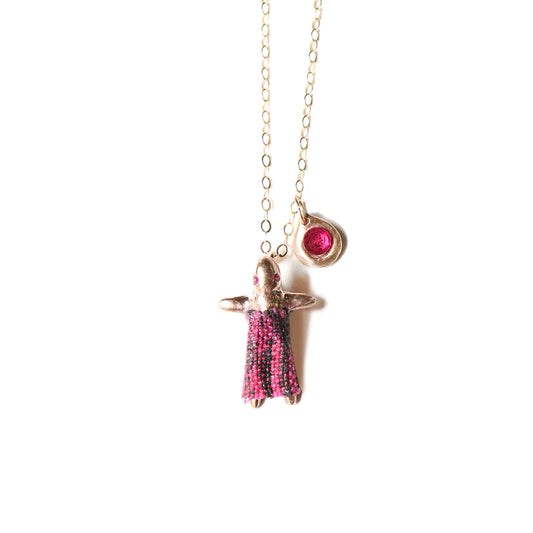 pink worry doll charm on a gold chain