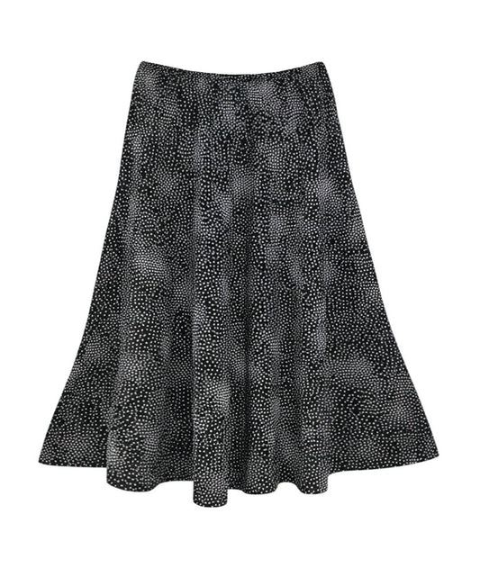 black skirt with a white dot print. skirt has 8 panels and an elastic waist yoke