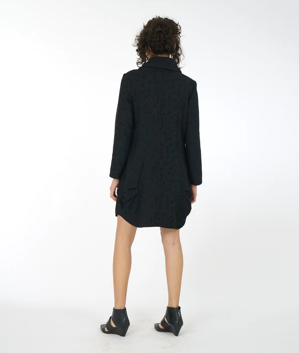 back view of model wearing a short black textured dress