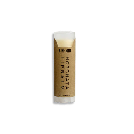 Horchata flavored lip balm in a clear plastic tube with brown paper label.
