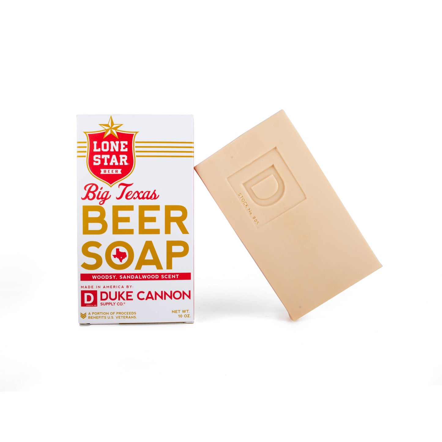 tan bar of soap leaning against a white and red carboard box labeled "Lone Star Beer. Big Texas Beer Soap"