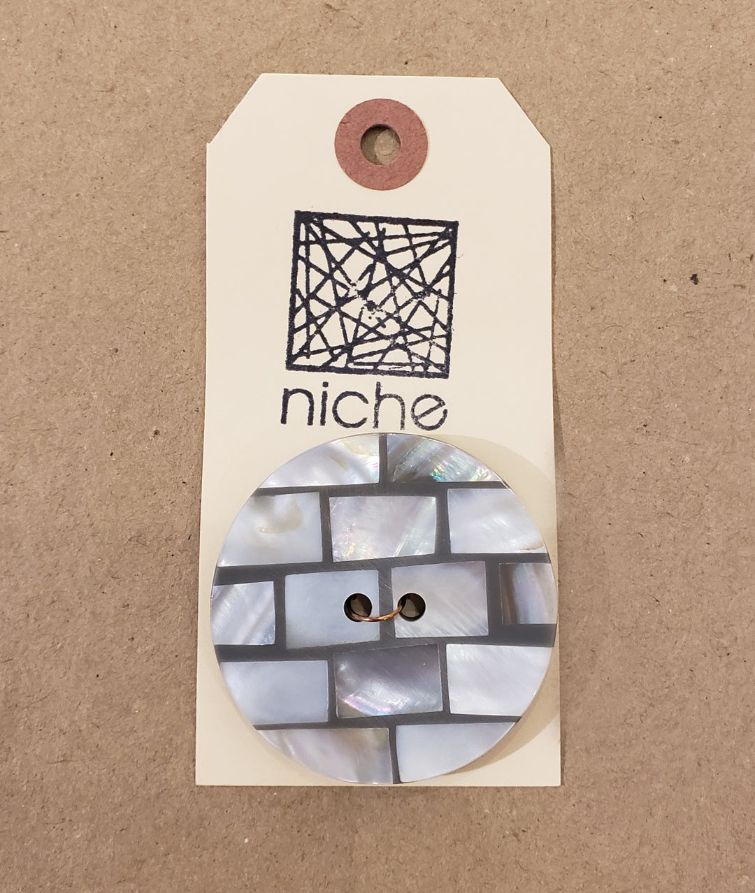 tiled button on a Niche card