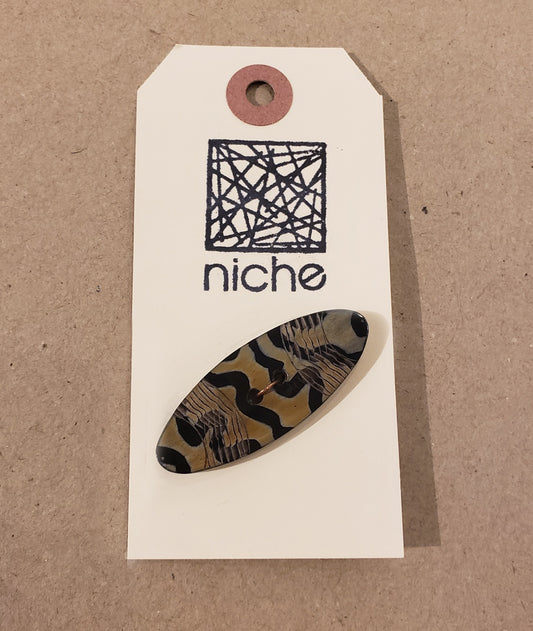 reptile print button on a Niche card