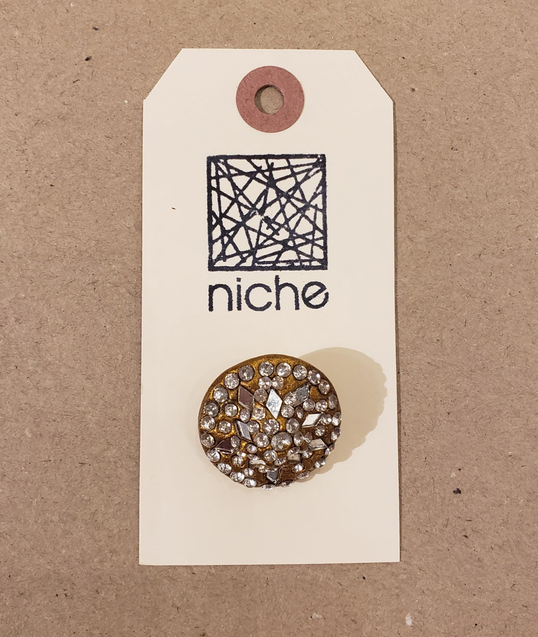 rhinestone button on a Niche card