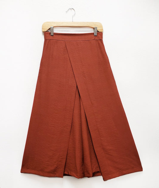 wide leg burn orange pant with a wide waistband and an overlapping  over layer in the front