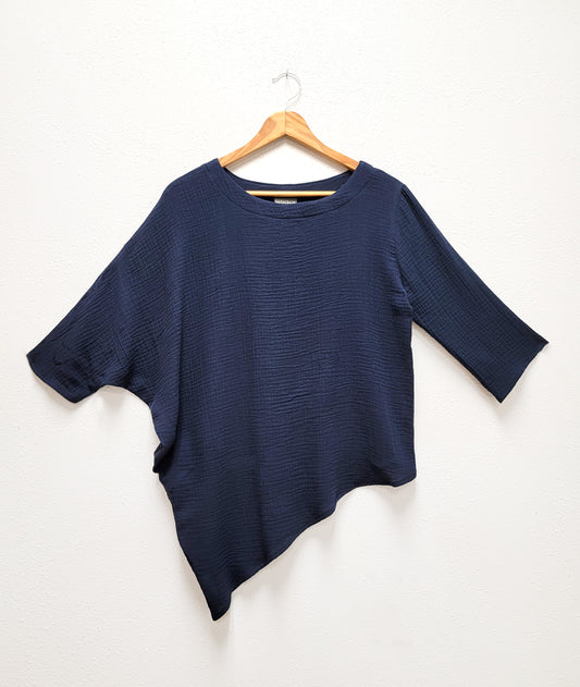 asymmetrical navy blue top with one draped side and sleeve