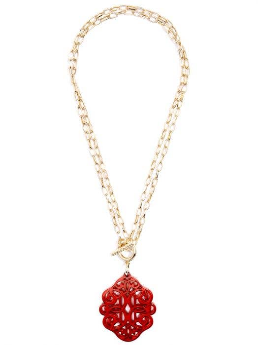 red pendant on a gold chain necklace
