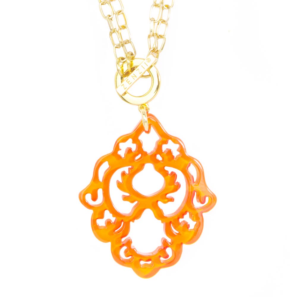 orange detailed pendant on a gold chain
