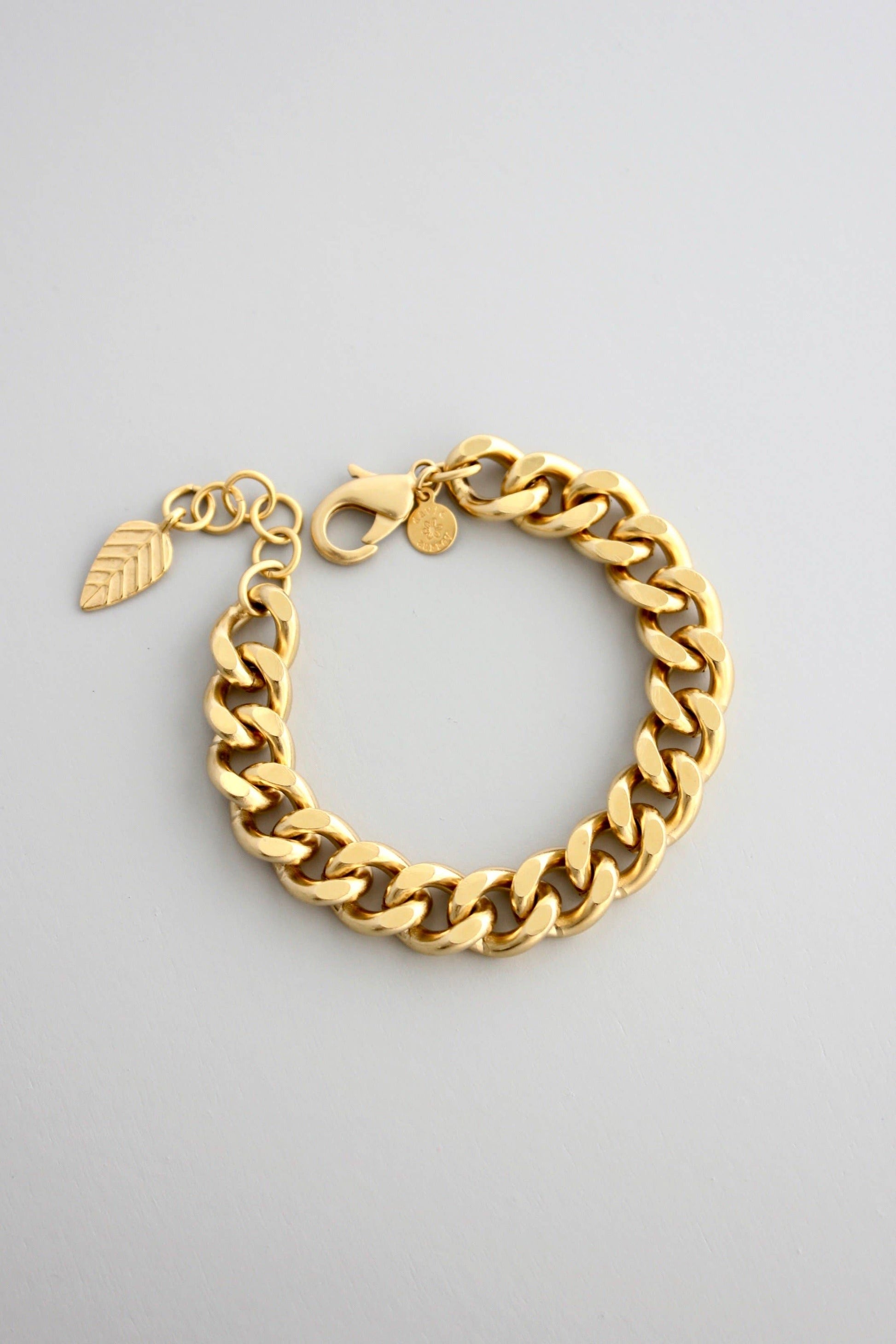 18k gold plated brass chain bracelet with one inch extender against a grey background