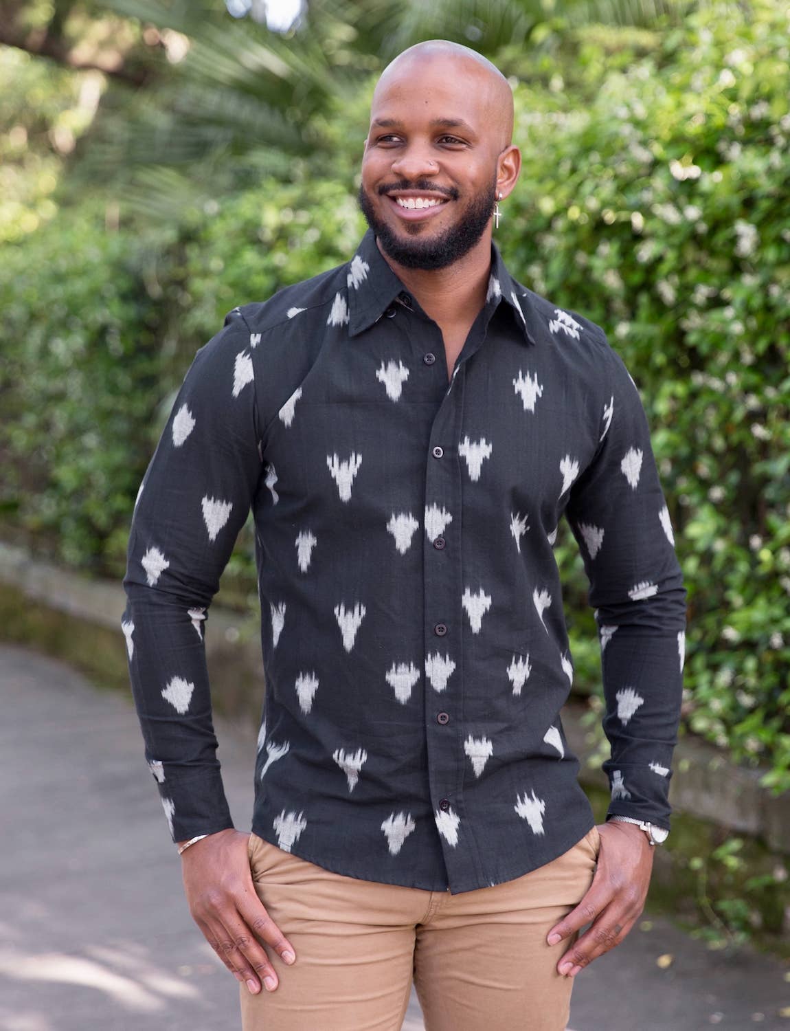 male model wearing long sleeved black shirt with digital cow print