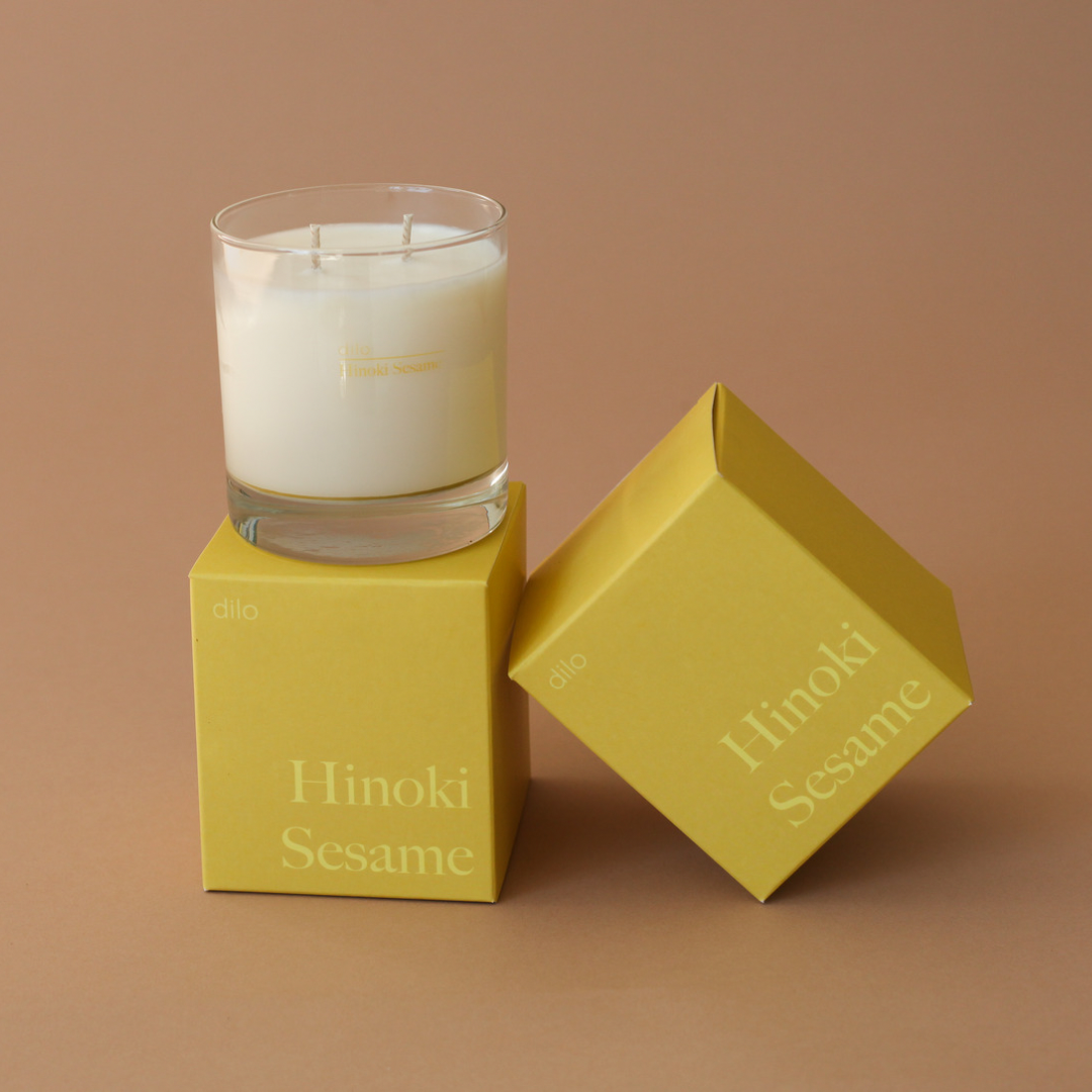 hinoki sesame scented candle with 2 of the packaging