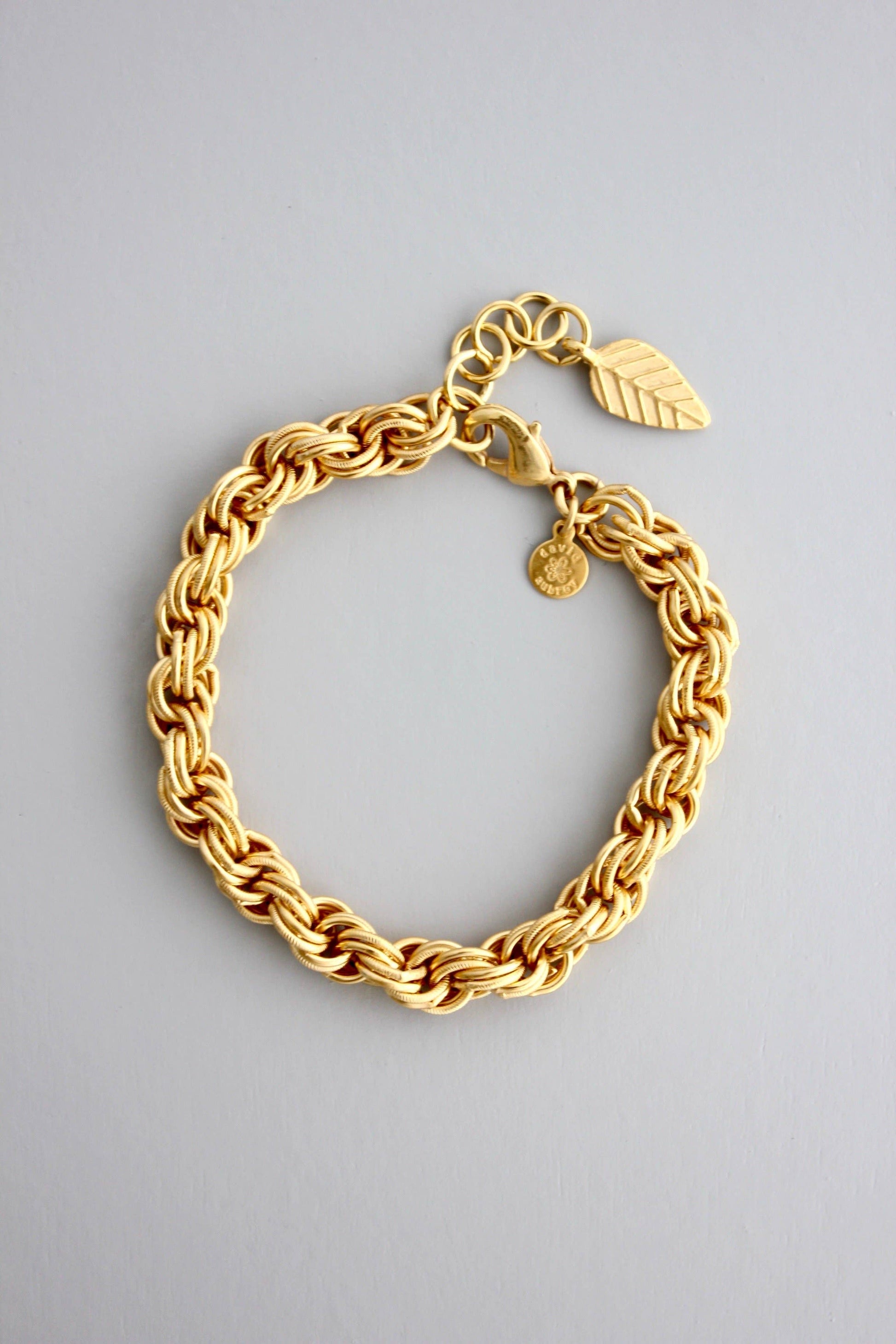 18k gold plated brass chain bracelet with one inch extender against a light grey background