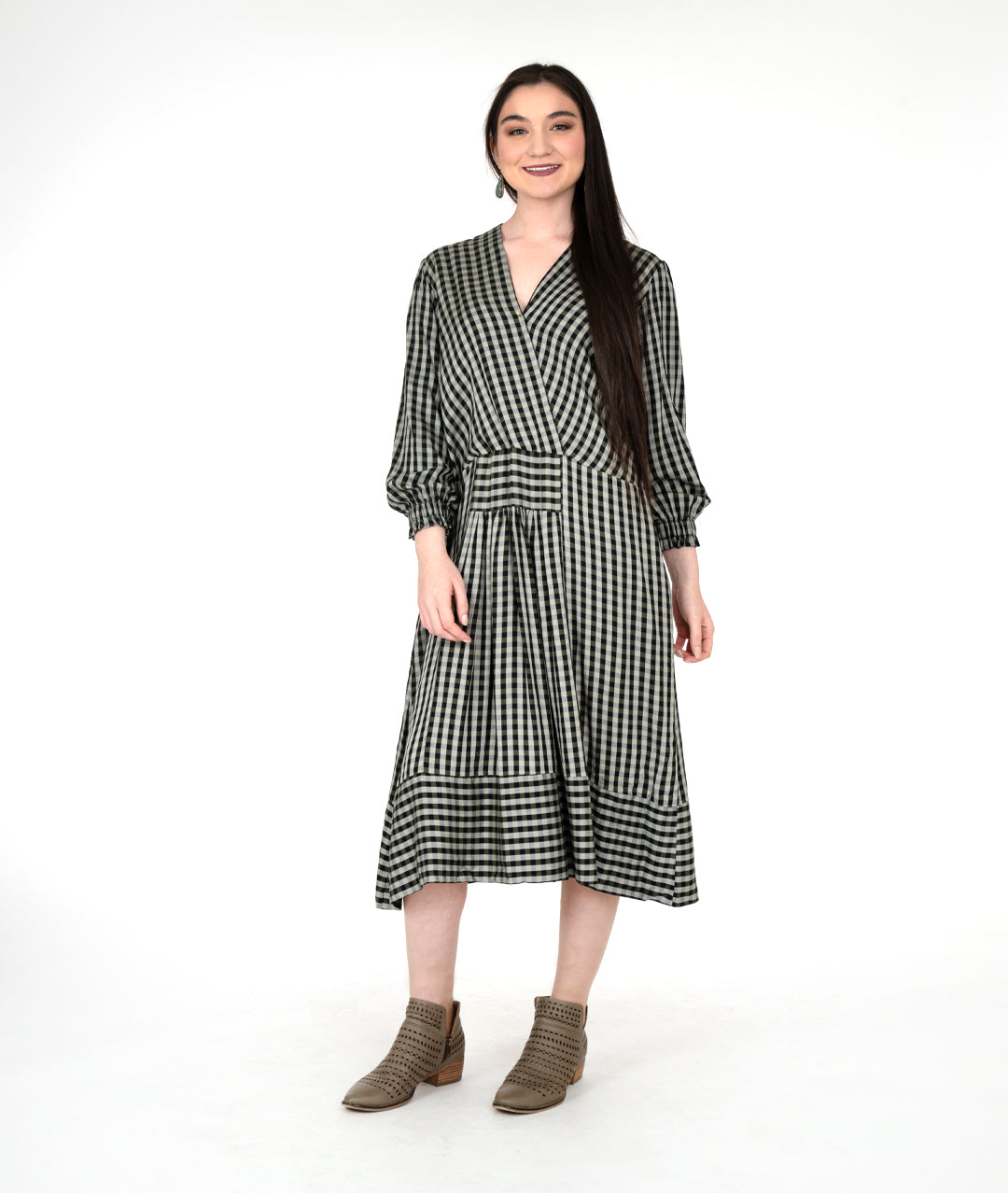 model in a green plaid dress with a full sleeve and contrasting hem panel