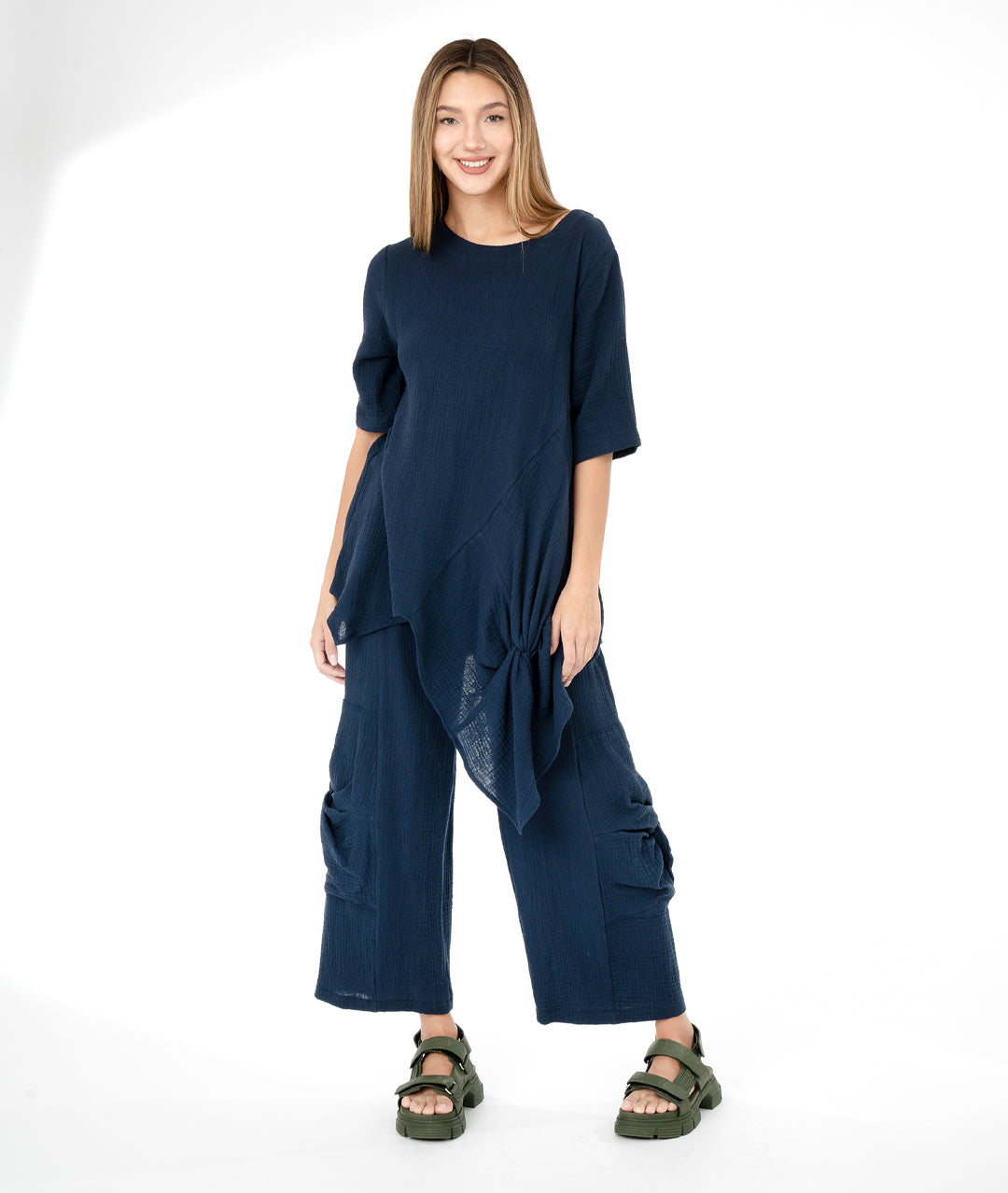 model in a navy blue top with a matching wide leg pant. top and bottom have large knot detail