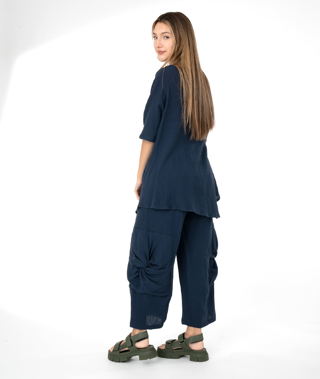 model in a navy blue top with a matching wide leg pant. top and bottom have large knot detail