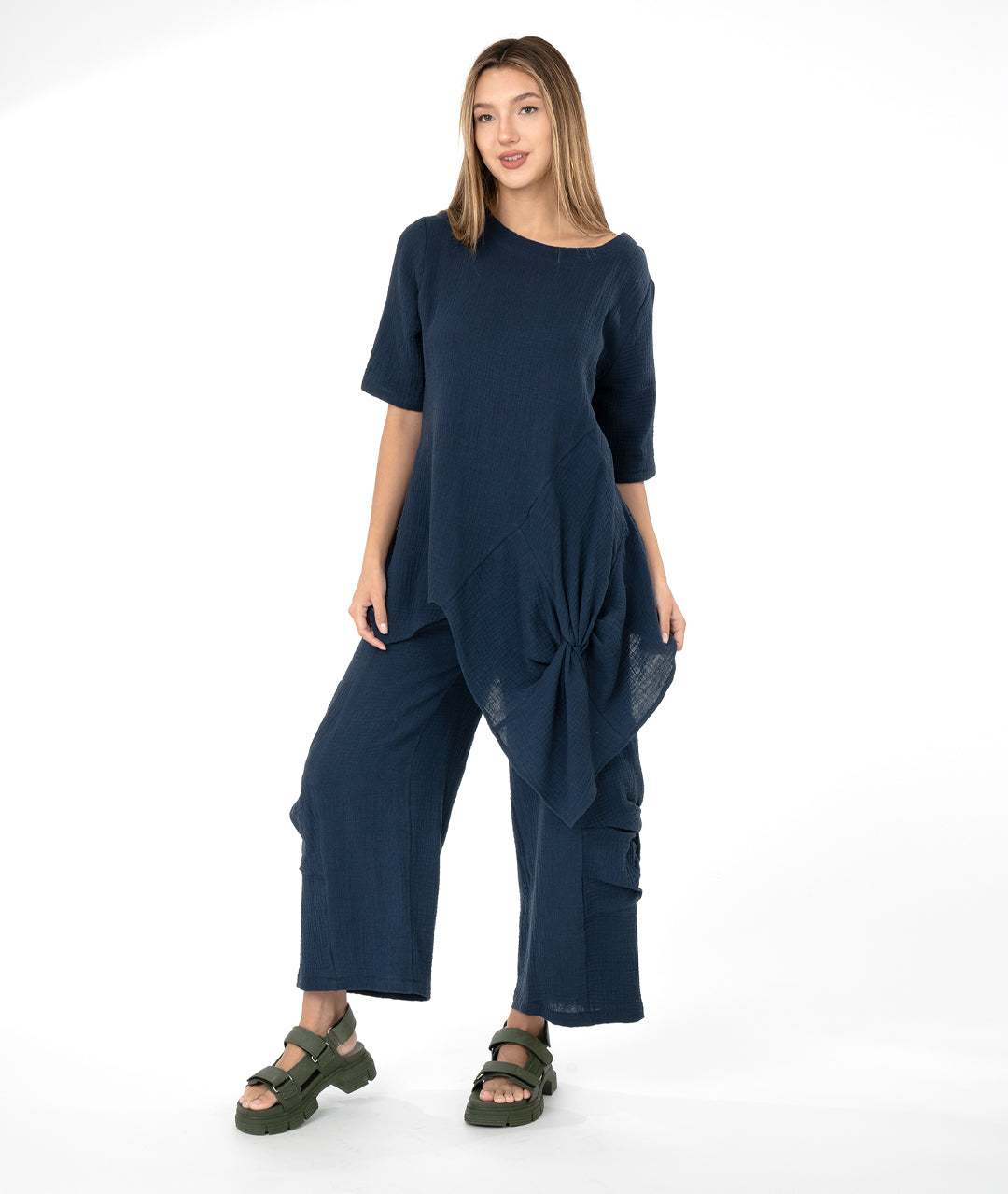 model in a navy blue top with a matching wide leg pant. top and bottom have large knot detail