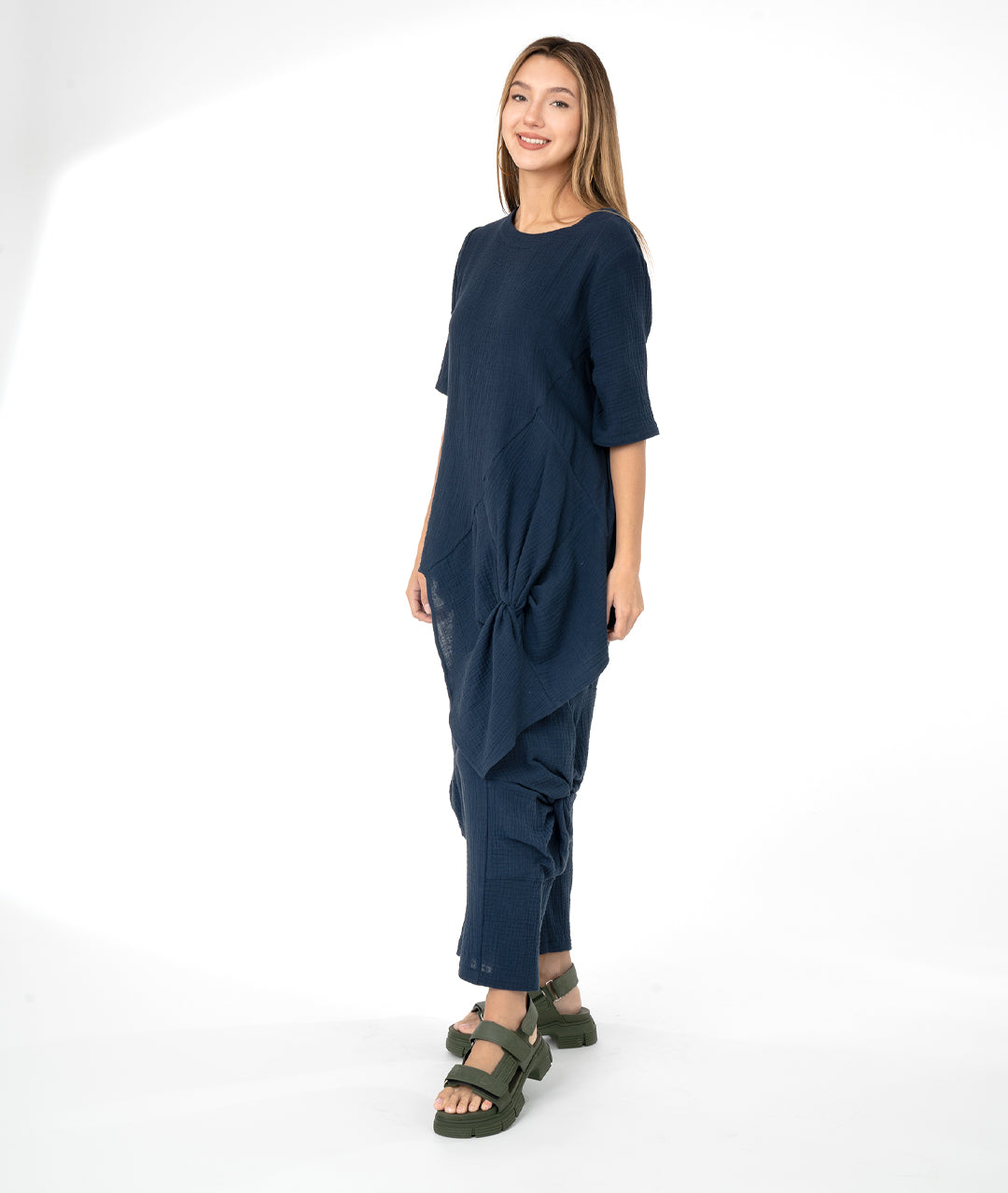 model in a navy blue top with a matching wide leg pant. top and bottom have large knot detail