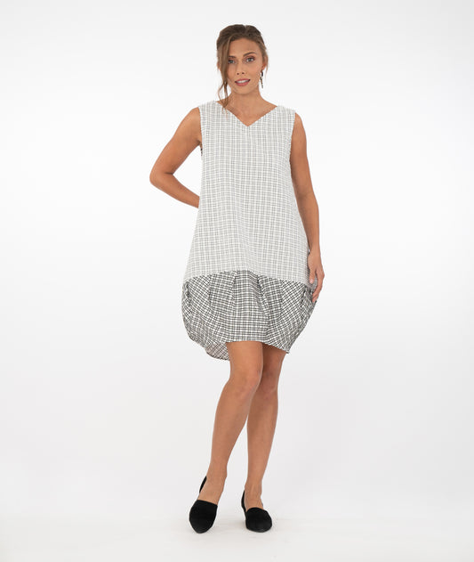 model in a two toned black and white tunic, with the bottom in a contrasting color way