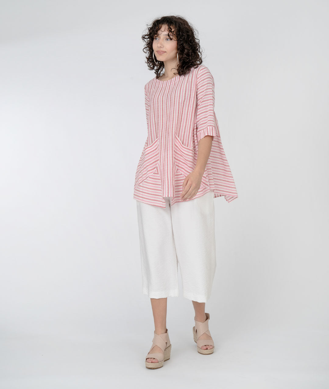 model in white cropped pants with a red and white striped white pullover top with a round neckline, 3/4 sleeves, half moon hip pockets