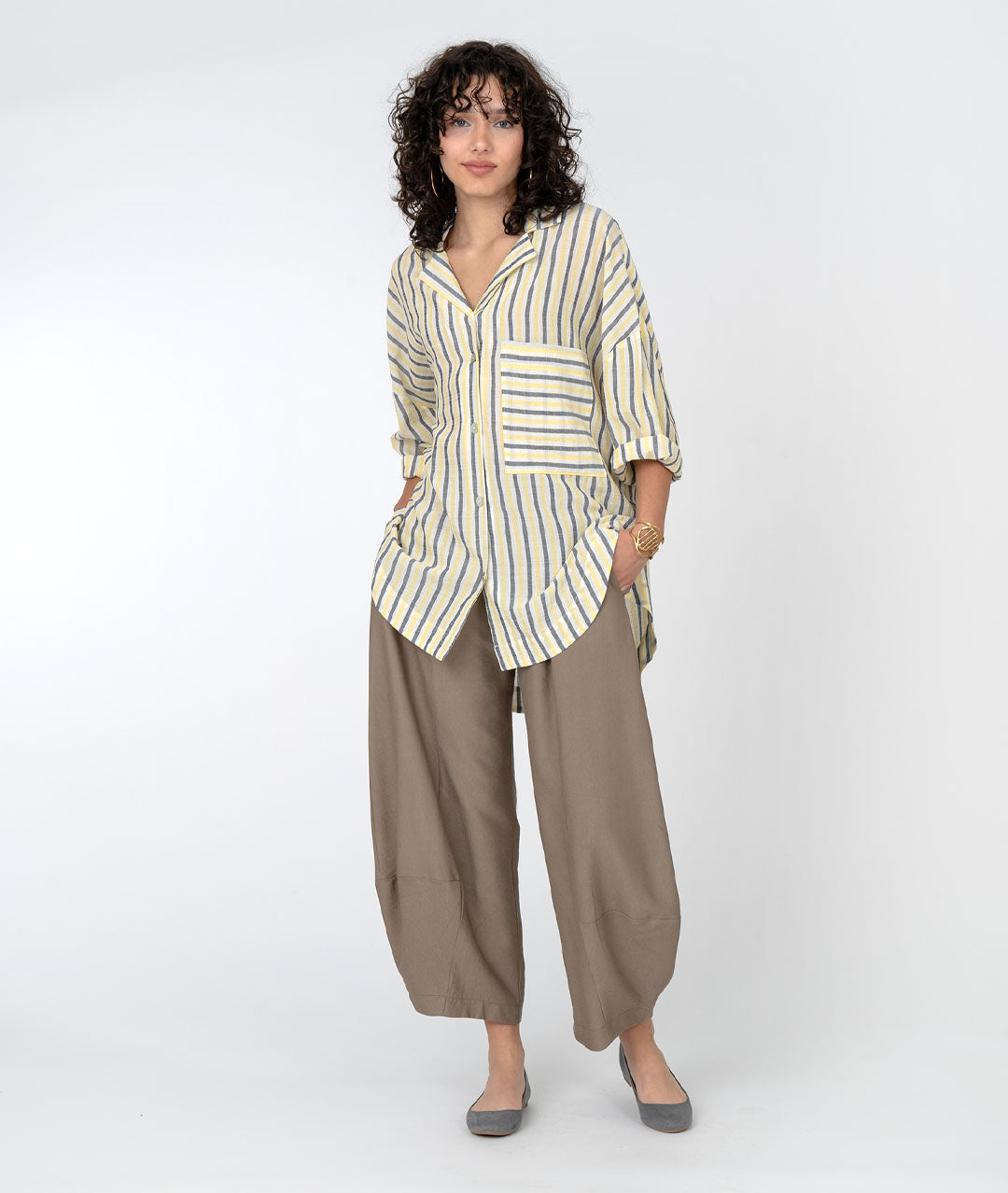 model in a wide leg brown pant with a yellow, grey and white striped collared blouse