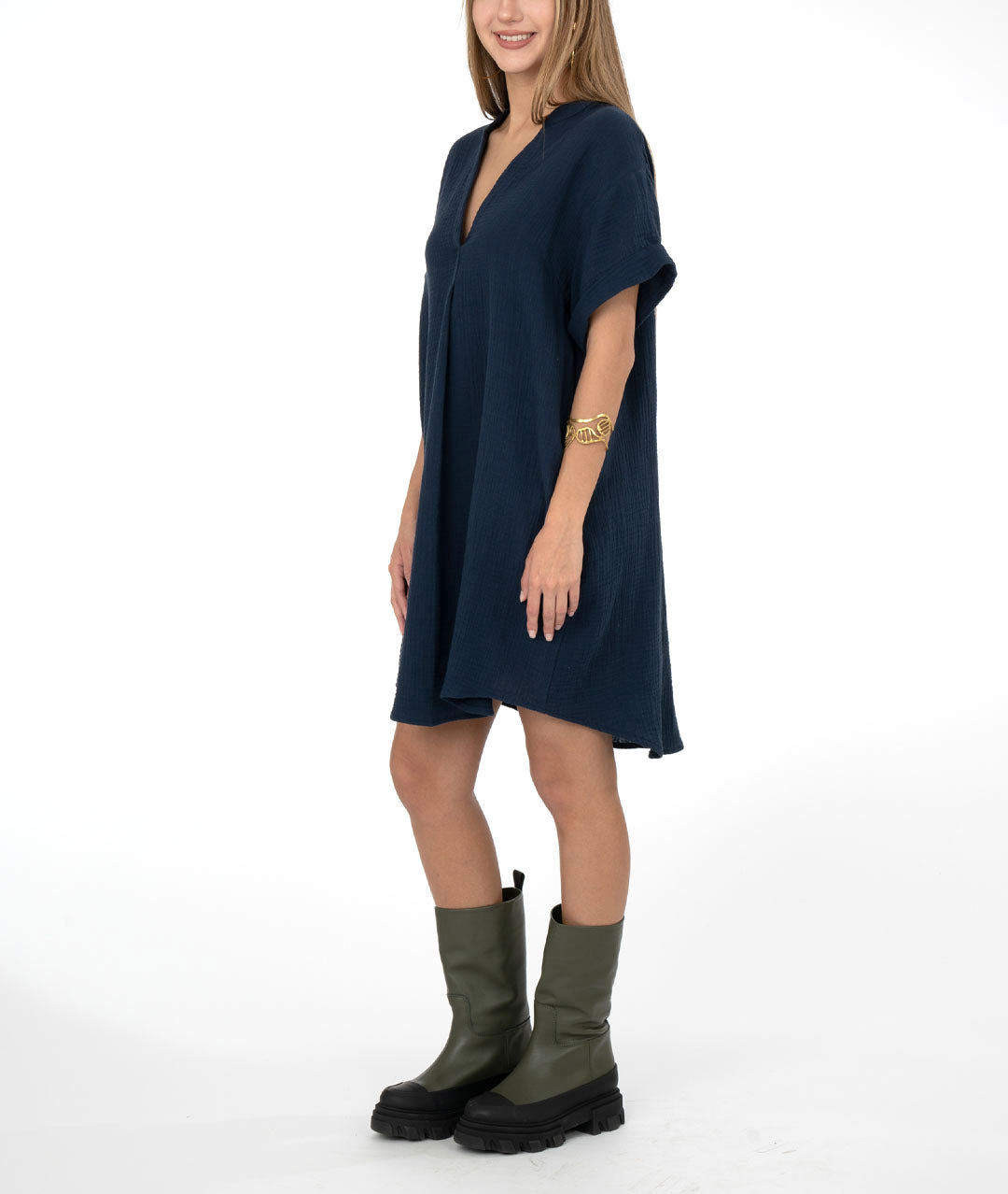 model in a navy blue pullover dress with a short cuffed sleeve, vneck, and pockets set in the side seams