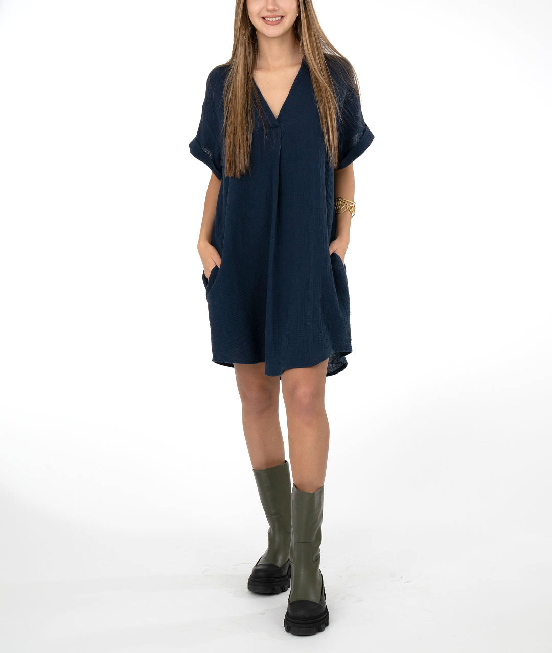 model in a navy blue pullover dress with a short cuffed sleeve, vneck, and pockets set in the side seams