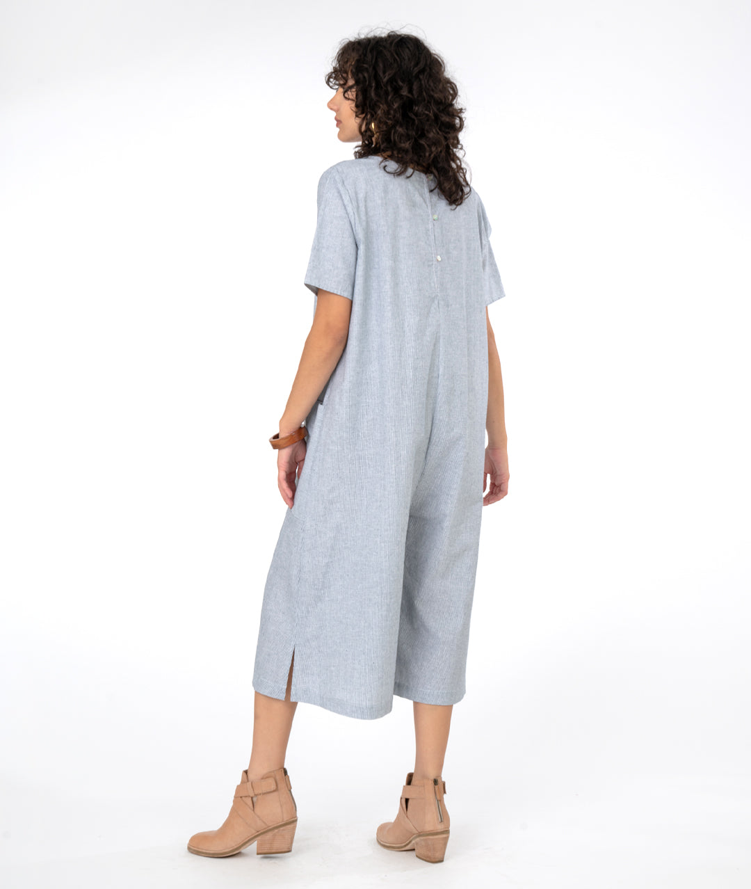 model in a wide, cropped leg jumpsuit with a loose fitting body, short sleeves and a vneck