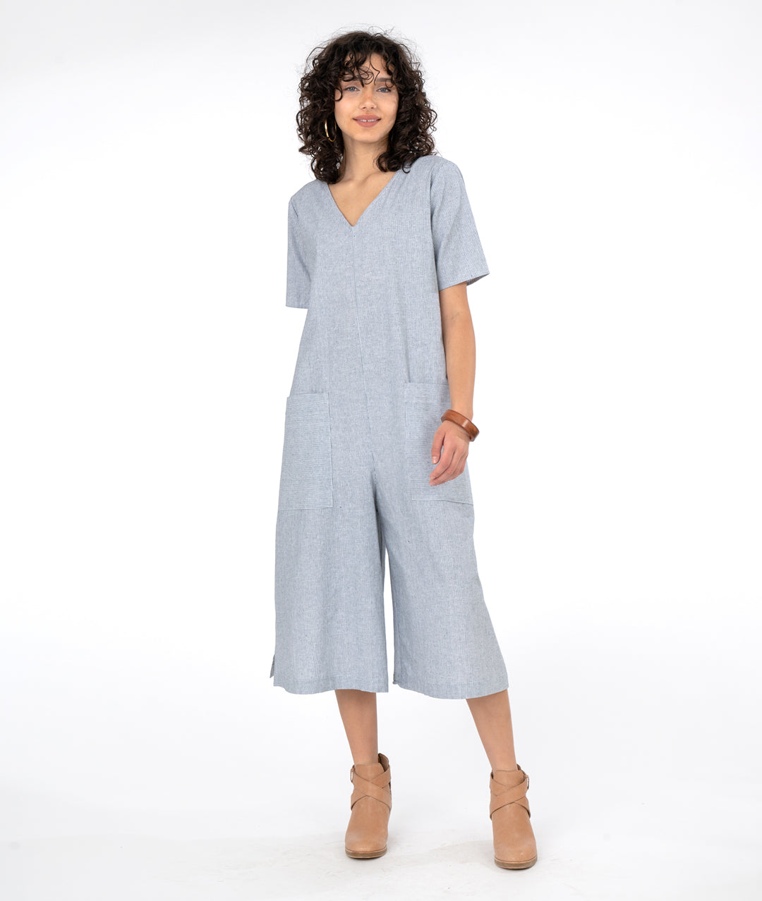 model in a wide, cropped leg jumpsuit with a loose fitting body, short sleeves and a vneck