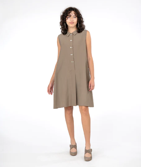 Brunette model wearing sleeveless shirt dress in in taupe and beige heels. On a white background.