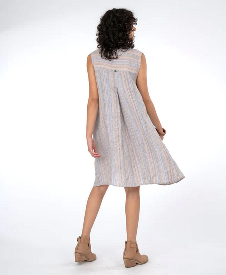 back view of Brunette model wearing sleeveless shirt dress in subtle stripe and tan booties. On a white background.