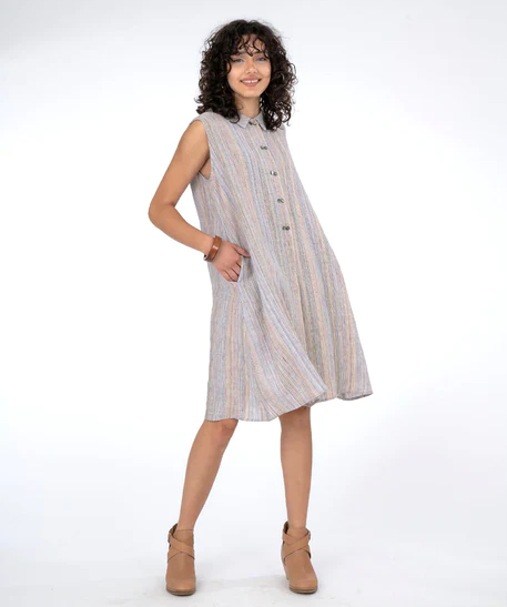 Brunette model wearing sleeveless shirt dress in subtle stripe and tan booties. On a white background.