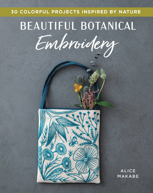 cover of a workbook called Beautiful Botanical Embroidery. The cover has a canvas floral person & the text.