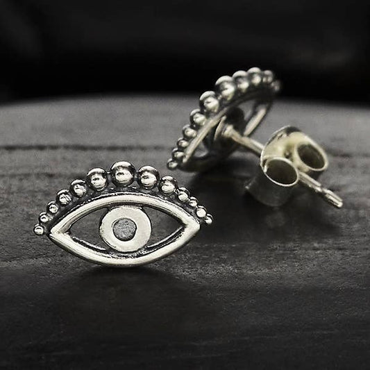 evil eye stud earrings in sterling silver. dark background