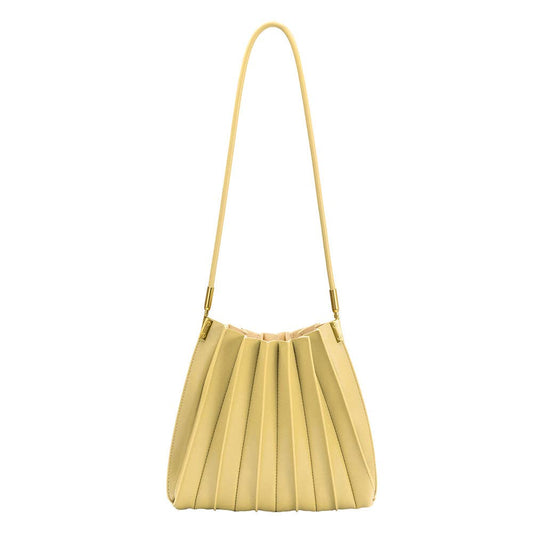 pale yellow pleated purse against a white background