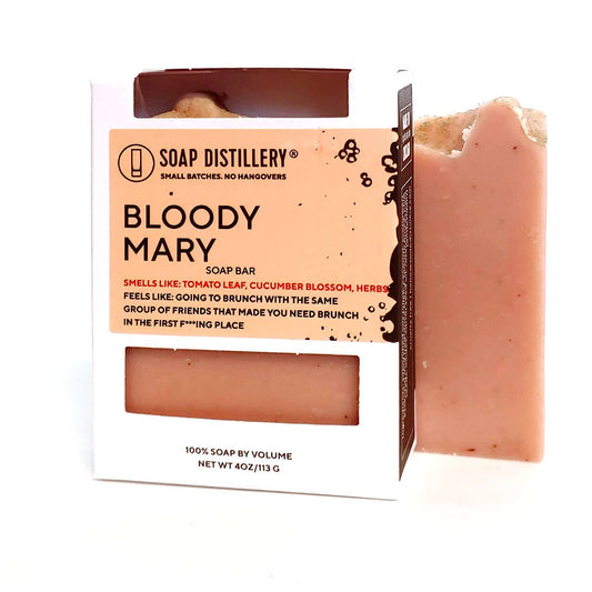 photo of light pink bar of soap in white packaging. scent is bloody mary. against a white background.