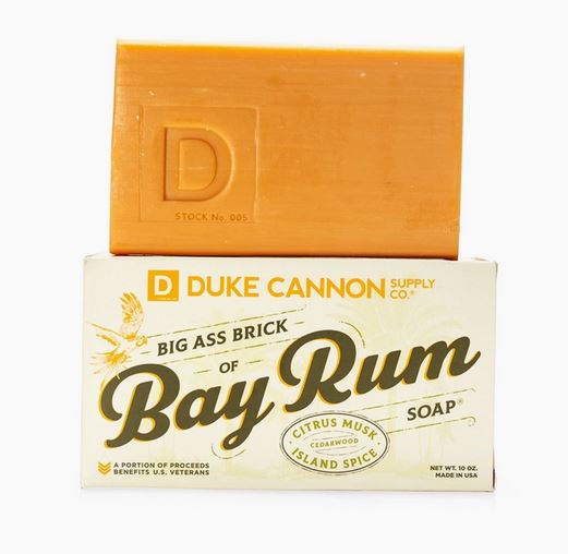dark yellow bar of soap sitting on top of its cardboard box labeled "Bay Rum"