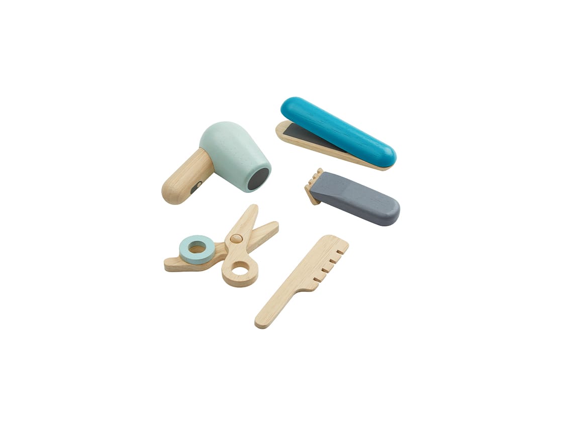 wooden toy play set featuring a blue hair straightener, clippers, wooden comb, wooden scissors, and a baby blue blow dryer. 