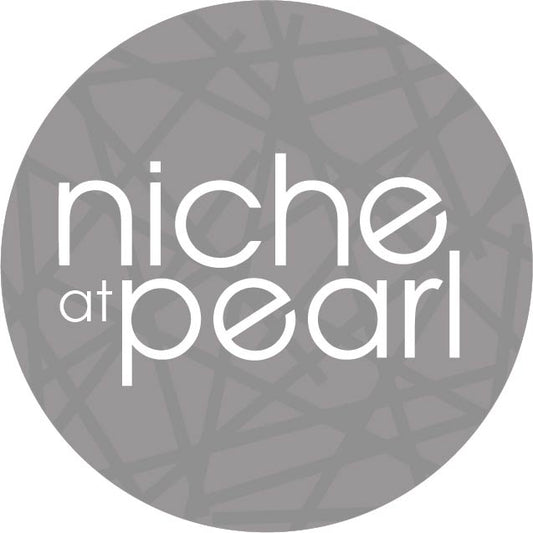 a gray circle with darker gray lines throughout it with white text over it reading "niche at pearl"