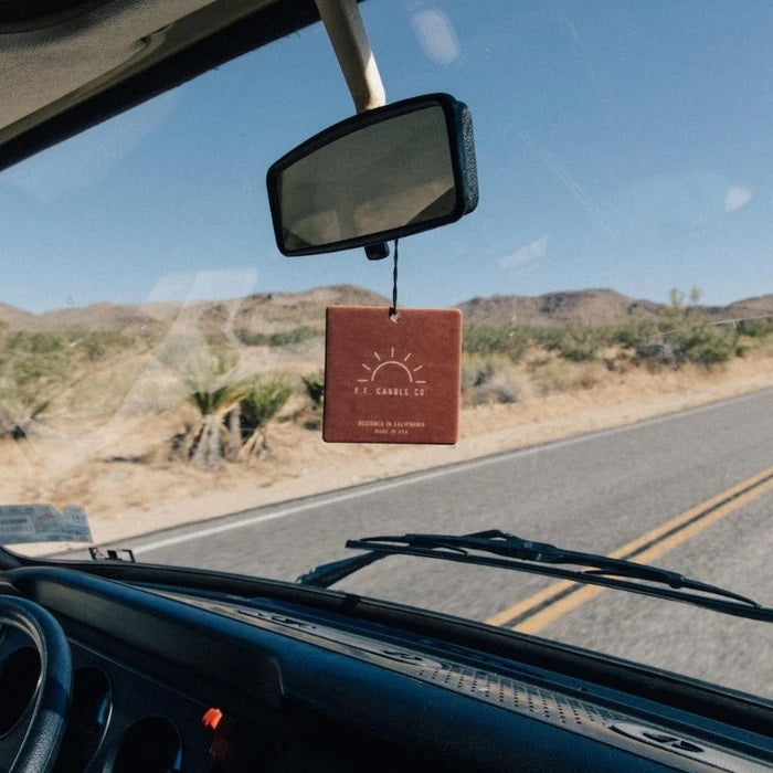 air freshener hanging from the rear view mirror of a vehicle